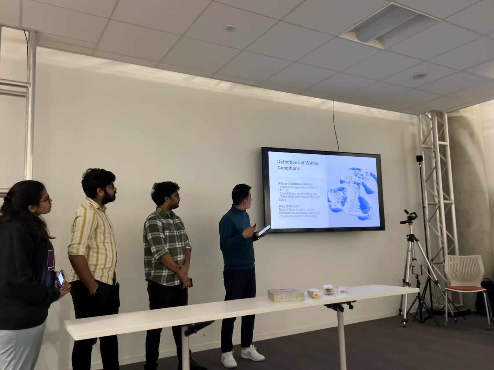 Final course project presentation slide and student speakers in Spring 2025