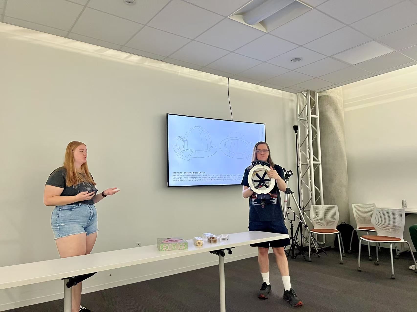 Spring 2025 course project presentation moment with student team at the front of the room